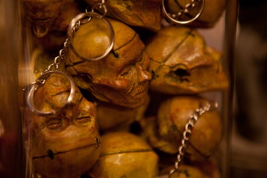 Key chains made from molds of the 100-year old human head in the shop.